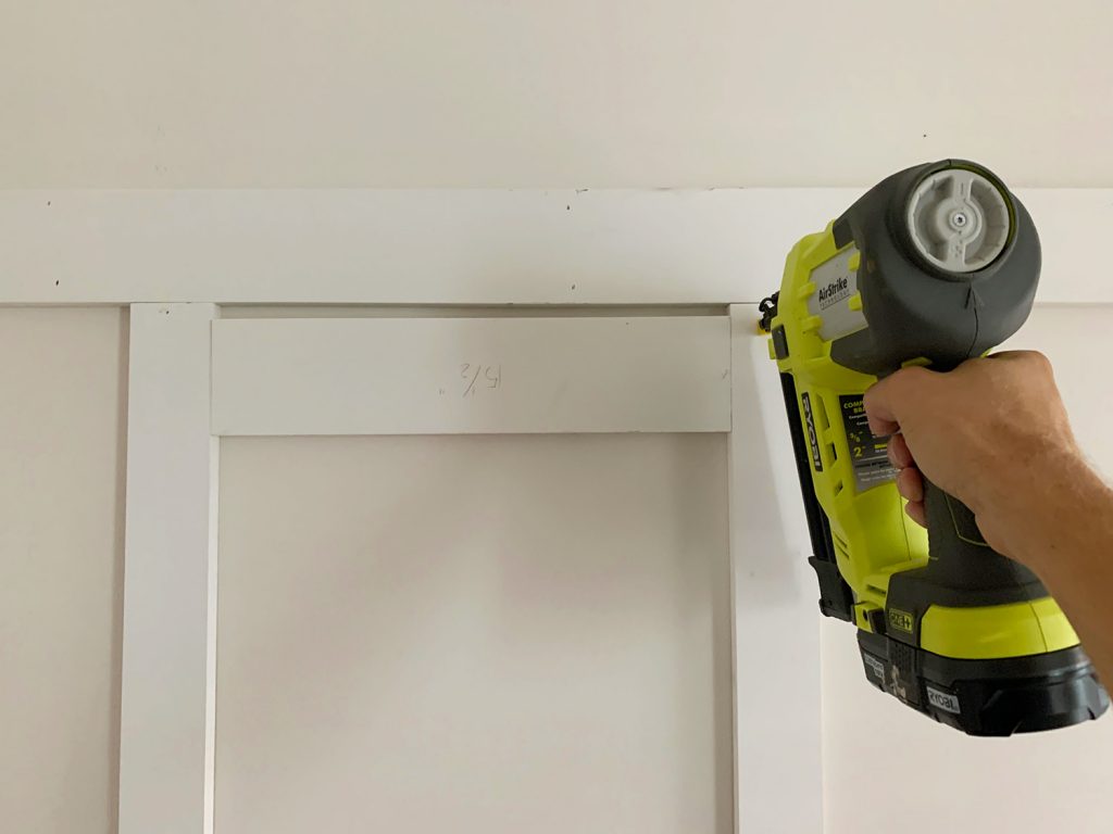 Installing Vertical Battens Using Nail Gun And Wood Spacer