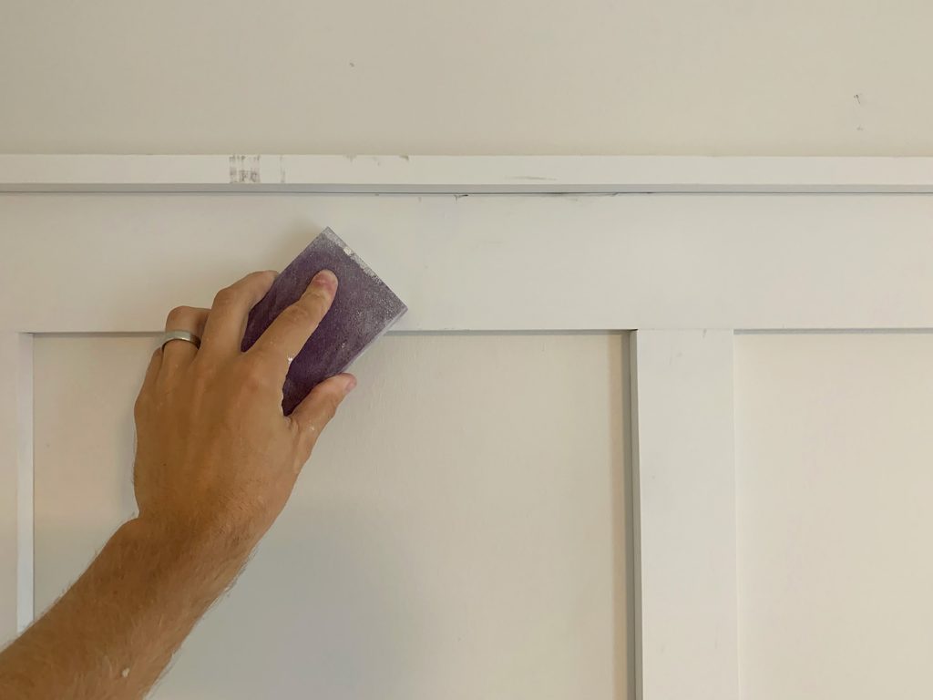 Sanding Block Being Used to Smooth Filled Holes On Board And Batten