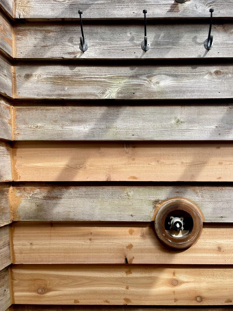 Outdoor Shower With Patches Of New Cedar Siding As Walls