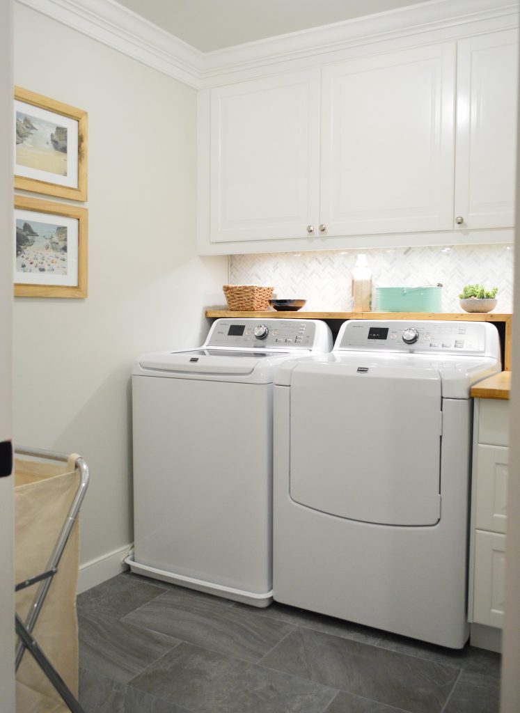 Tiled laundry room with wood butcher block DIY shelf over washer and dryer