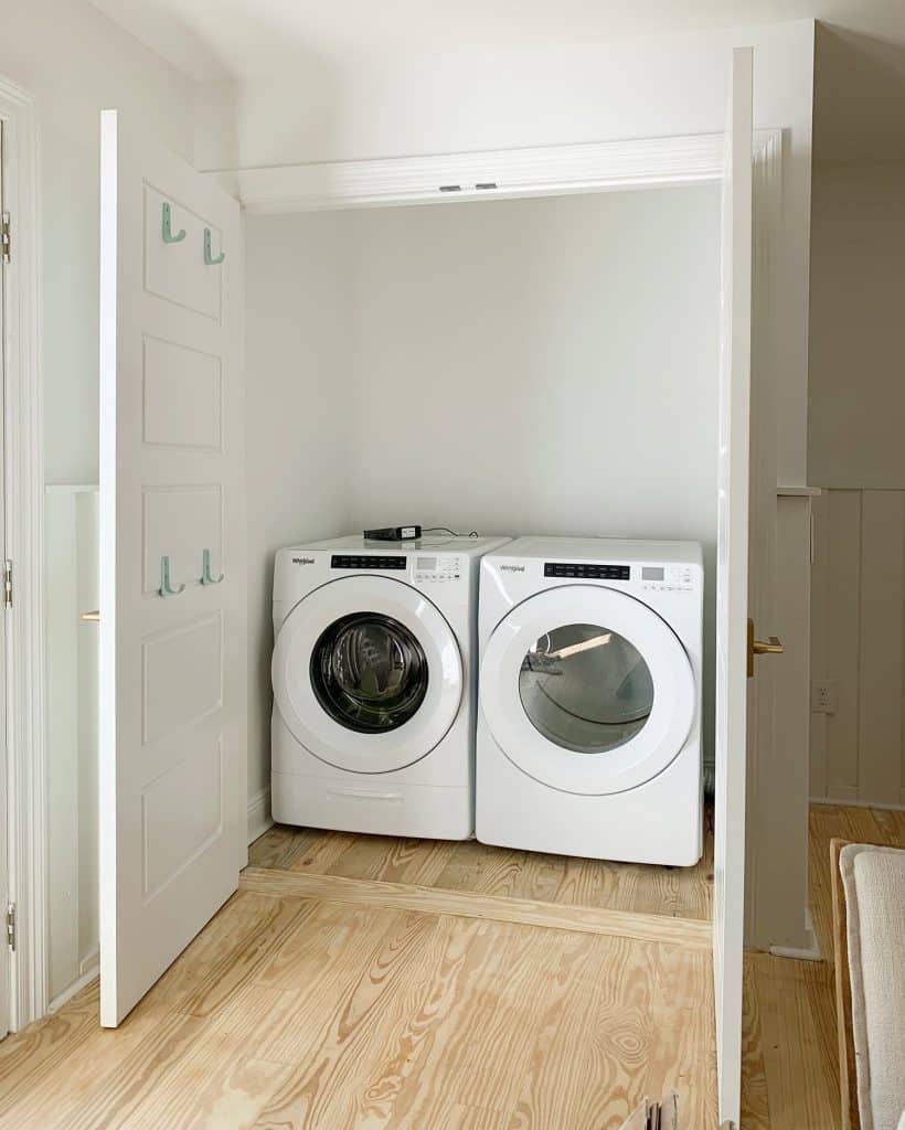 Empty laundry closet with front loading washer and dryer