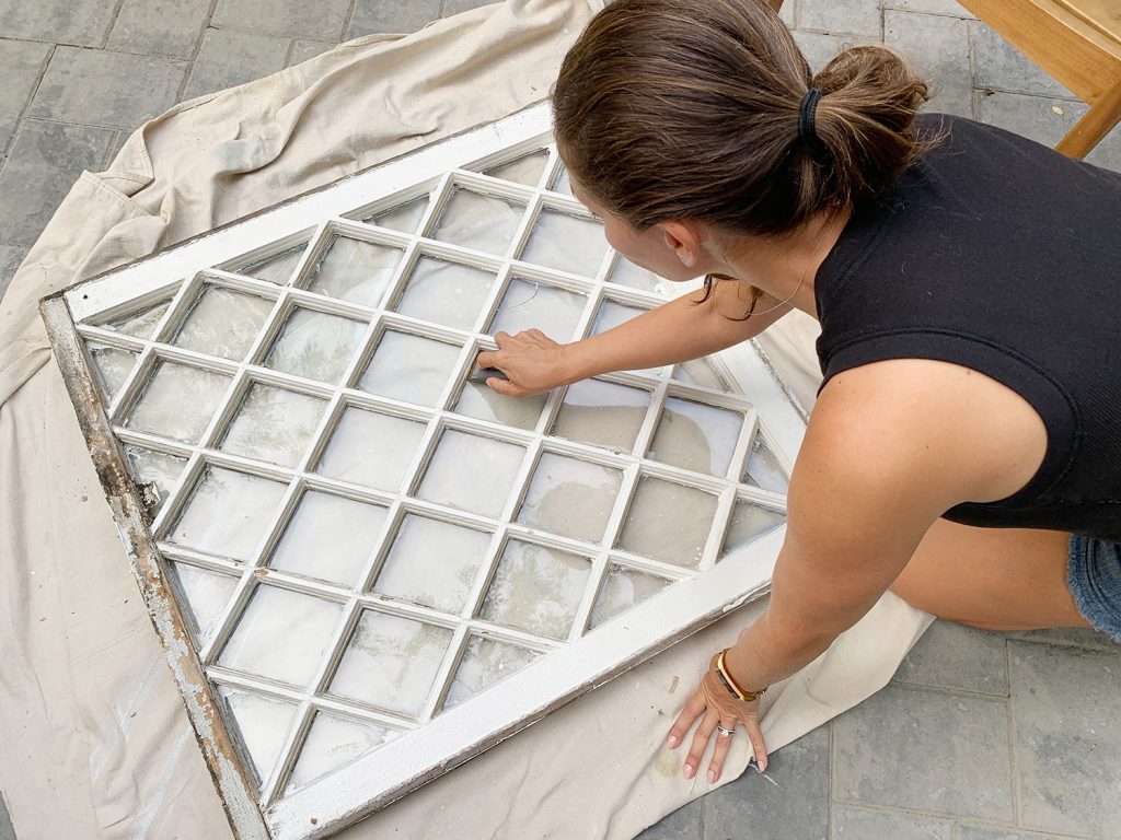 Sherry Scraping Glass Window Clean Before Hanging