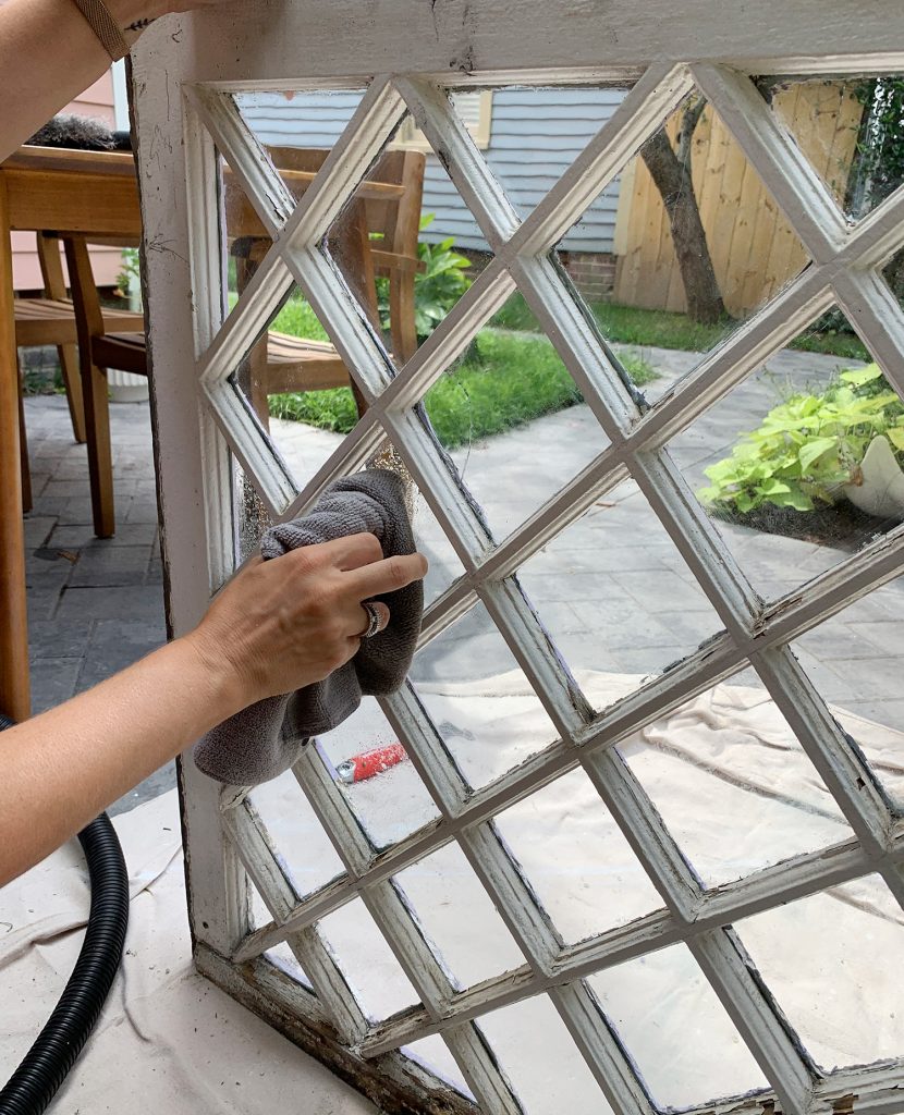 Wiping Glass Clean On Old Diamond Pane Window