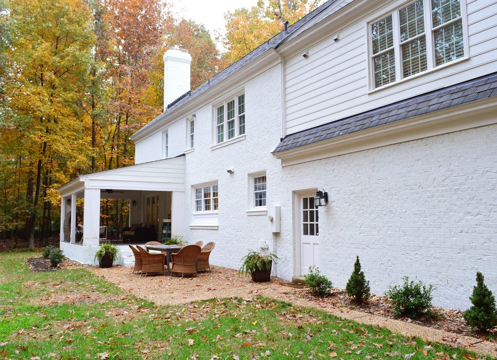 White brick house with empty wall near garage