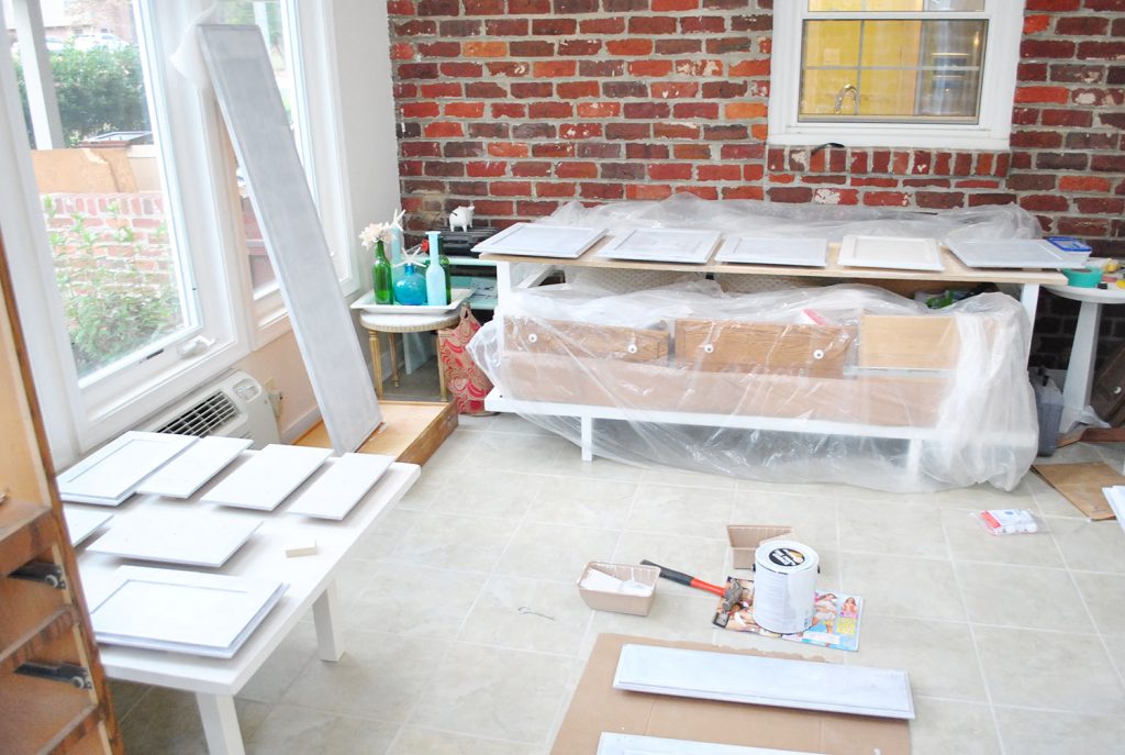 Cabinet Doors Get Painted In Sunroom On Paint Risers