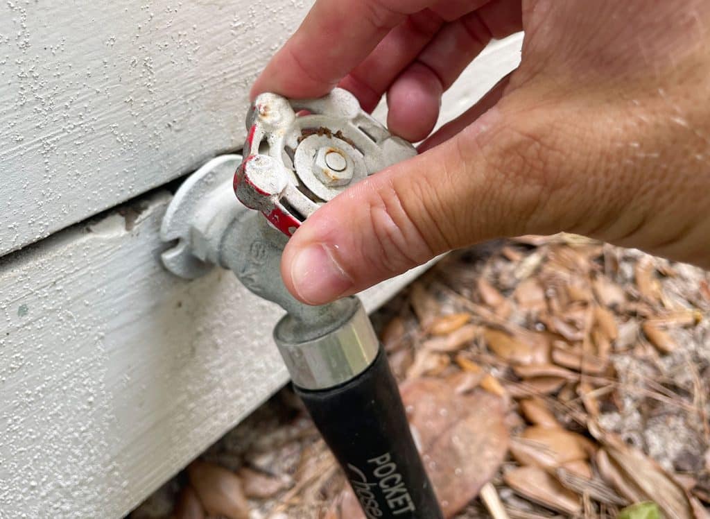 Turning on water at outdoor hose bib for pressure washing