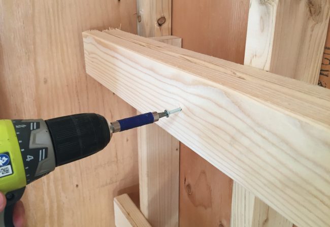 screwing in horizontal support for DIY garage shelf