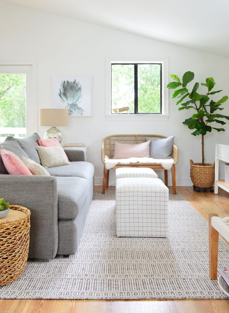 Family Room With Couch Striped Ottomans And Woven Bench