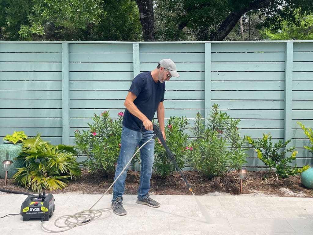 John pressure washing pool deck patio with Ryobi electric power washer