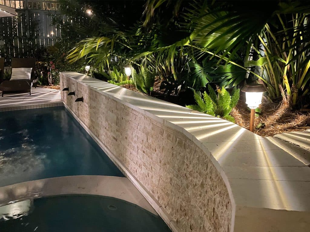 LED Solar Pathway Lights Along Retaining Wall Near Backyard Pool